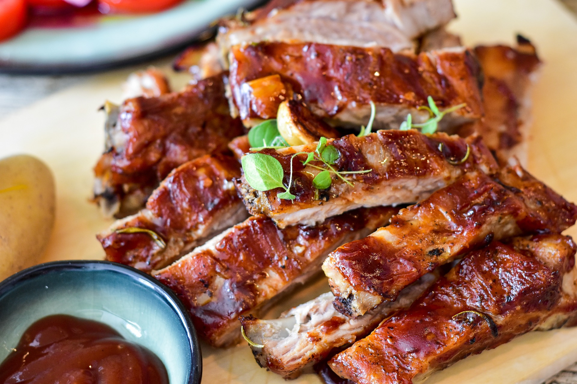 Barbeque ribs on a sheet of brown paper.